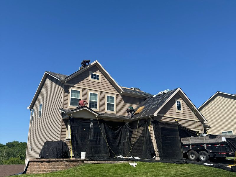 Reliant crew documenting hail and storm damage on a St. Louis roof