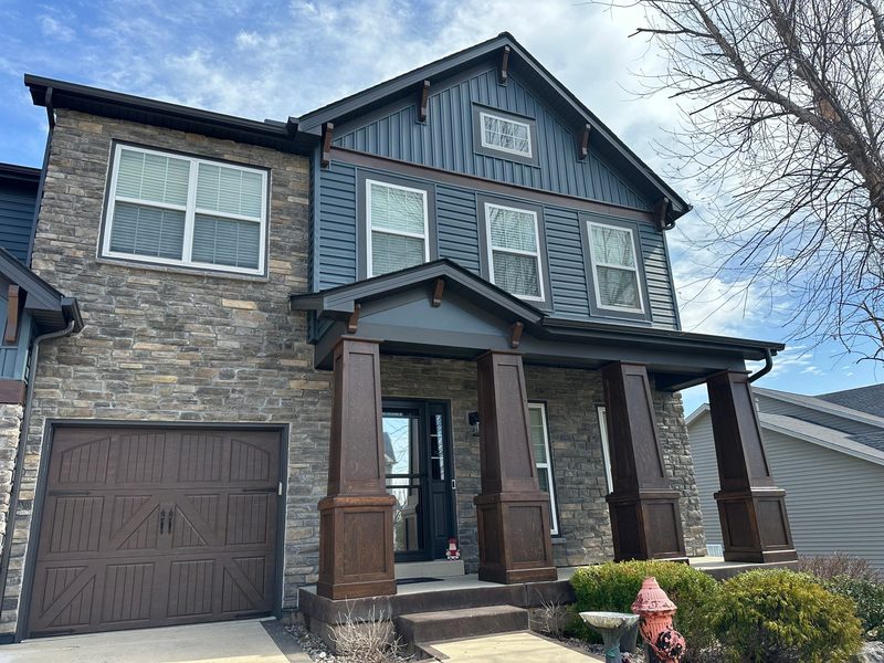 A craftsman-style St. Louis home with new board-and-batten and stone siding installed by Reliant Exteriors
