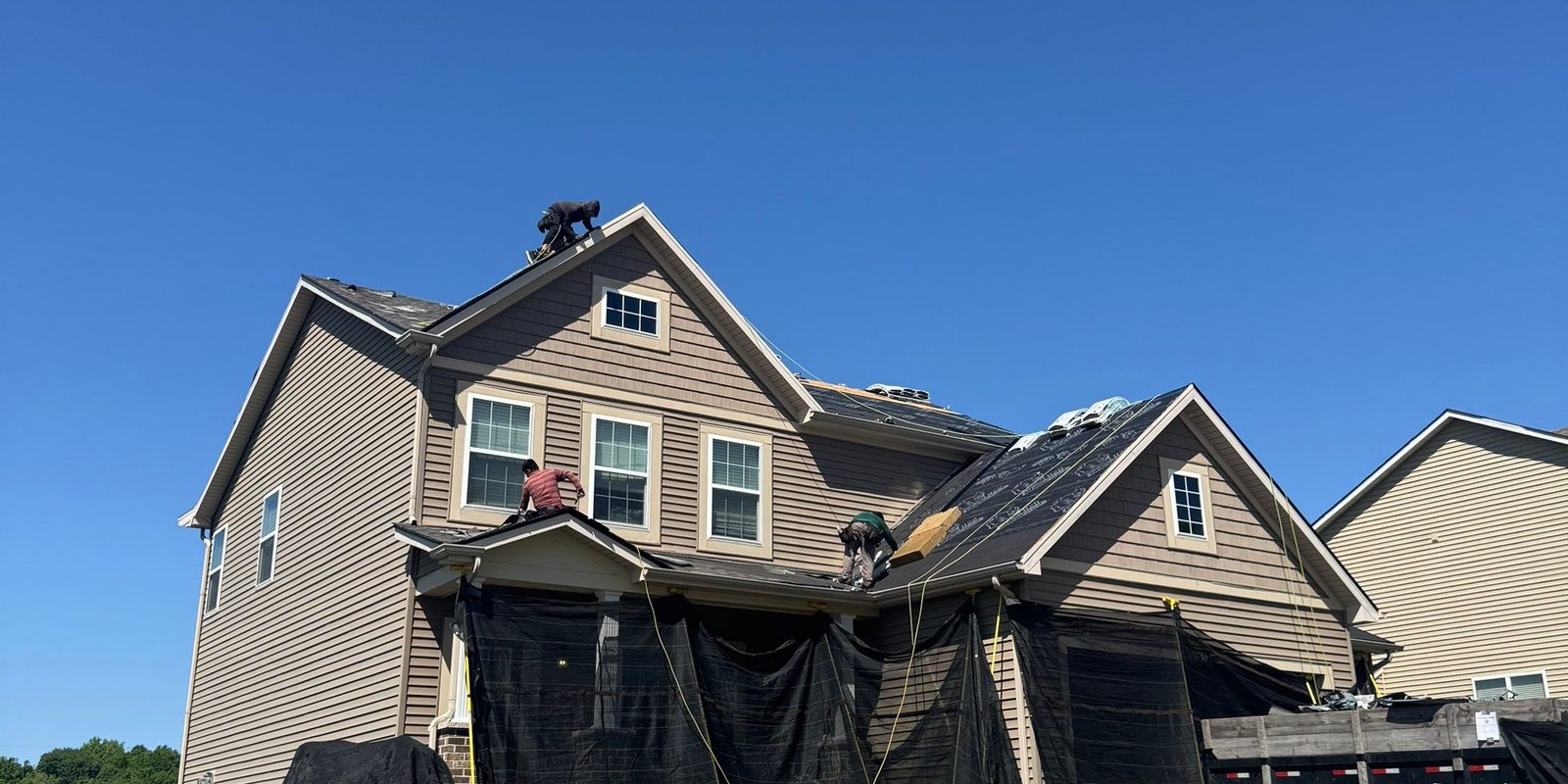 Reliant Exteriors crew documenting hail and storm damage scope on a St. Louis roof